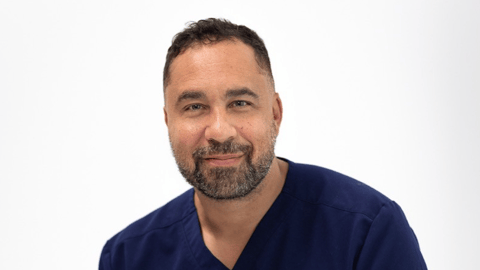 Dr. Jean-Paul Brutus in blue scrubs