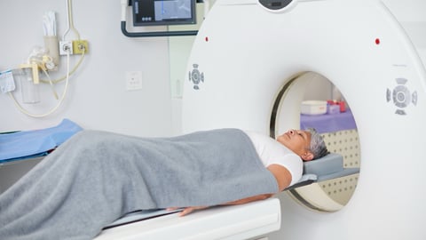A patient enters an MRI machine at a hospital.