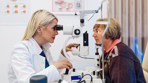 An ophthalmologist exams a patient.