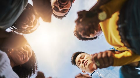 A group of people in a prayer circle