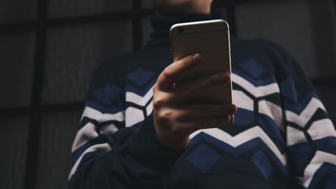 Young teen boy looking at a smartphone