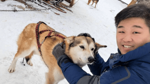 Pei Hsuan Tsai petting a dog outside on a winter day