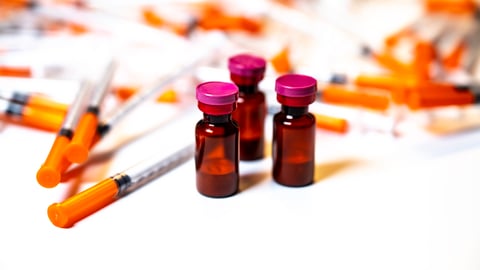 A pile of vials and syringes