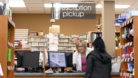 A person picks up her prescription at a pharmacy in Port Coquitlam, B.C.