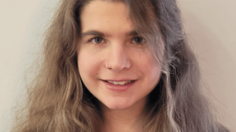 Dr. Eva Asselin, a young physician resident with long hair in a grey shirt
