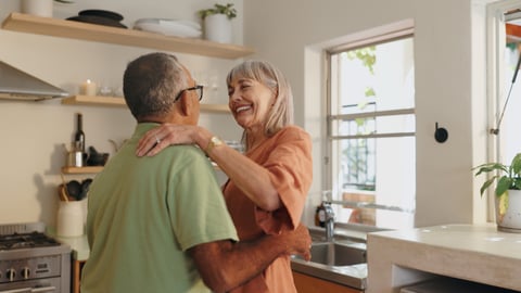 Older couple dancing in the kitchen