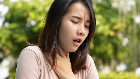 A woman having hiccups.