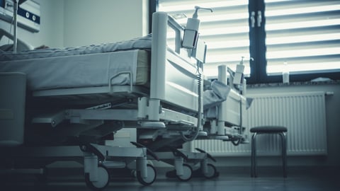 Hospital beds in a hospital room.