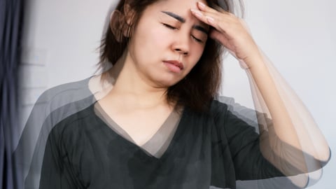 Woman holding her head feeling dizzy