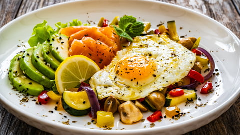 Plate showing fried egg, salmon and avocado, representing keto / low-carb diet