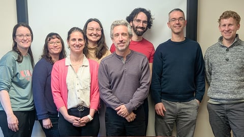 A group of healthcare workers together smiling for a photo