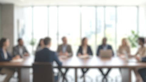 A blurry wide shot of a board meeting
