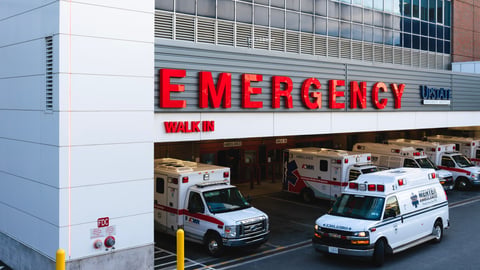 front of hospital with big red "Emergency" sign