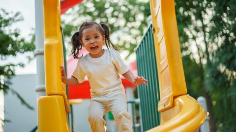 Little girl playing on the playground