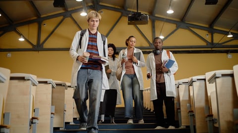Young medical students entering a lecture hall