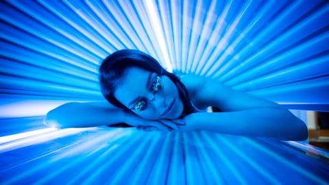 Young woman in a tanning bed