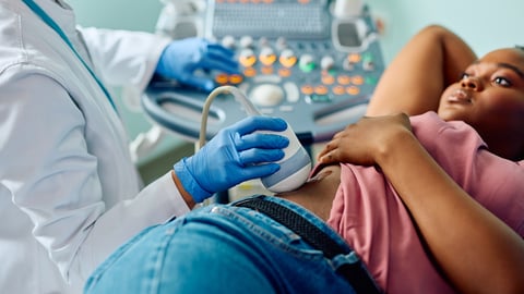Young Black woman getting an ultrasound on her side