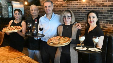 Shawn Hatami (middle left), Shirin Hatami (middle right) and the rest of the staff from Roma Italian Restaurant. (Abby Luciano / North Shore News)