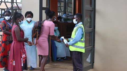 A lady sanitizes her hands before entering church as catholics attend holy mass at Uganda Martyrs Catholic Basilica Namugongo on June 3, 2026 in Kampala Uganda.