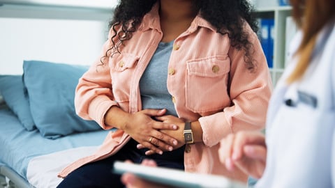 Pain, gynecologist and doctor with woman in hospital for consulting, appointment and endometriosis
