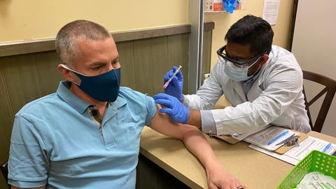A man gets a COVID-19 vaccine at a pharmacy in Calgary.