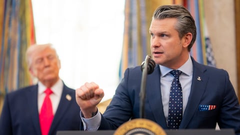 U.S. Secretary of Defense Pete Hegseth speaks at the White House in front of President Donald Trump.
