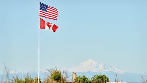 US and Canadian Flags fly in Point Roberts, Washington