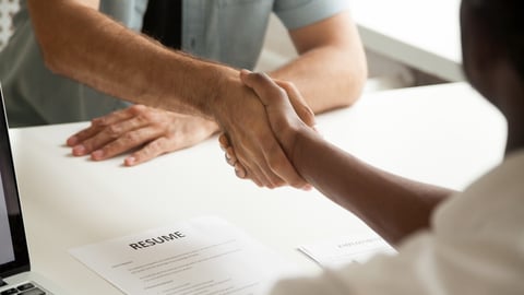 Employment handshake or making good first impression at successful interview concept, african employer and caucasian employee shake hands, black recruiter welcoming new white job candidate, close up; Shutterstock ID 1017665212