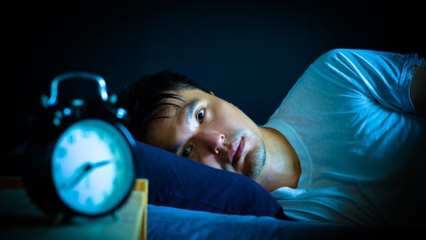 asian man in bed suffering insomnia and sleep disorder thinking about his problem at night; Shutterstock ID 1106545967