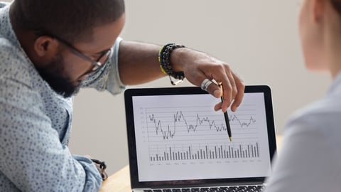 Focused african analyst showing client or colleague annual financial report analyzing business data on laptop screen using software for digital graphic statistic analysis, economic market graphs ; Shutterstock ID 1368244205
