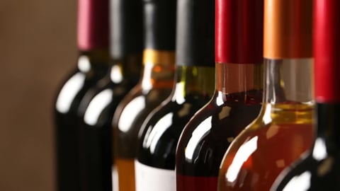 Bottles of different wines, closeup. Expensive collection; Shutterstock ID 1408214771