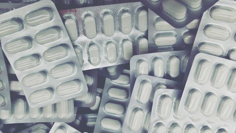 packaging of silvery tablets in purple tones; Shutterstock ID 1689424147