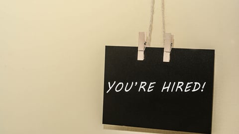 Hiring employee concept for business, website advertising and others.`You're Hired` text on the hanging small board.; Shutterstock ID 1697166766