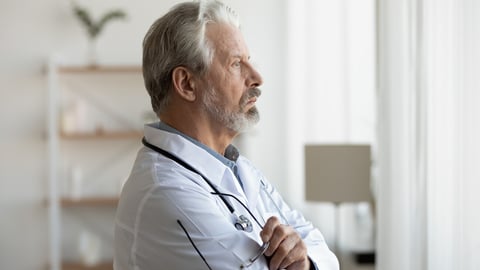 Thoughtful serious senior doctor looking through window lost in thoughts. Worried pensive old physician thinking of healthcare question, concerned of challenge, feels anxious makes difficult decision.; Shutterstock ID 1720780102