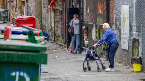 Vancouver, British Columbia/Canada - 09/08/2018: An elderly lady watches on as two young men seek methadone in a back alleyway in Vancouver, British Columbia; Shutterstock ID 1737441326