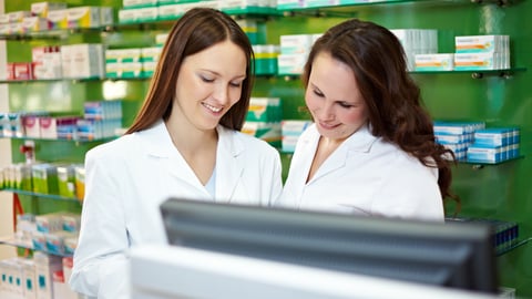 Pharmacist in pharmacy is training to be a PTA; Shutterstock ID 1830179318