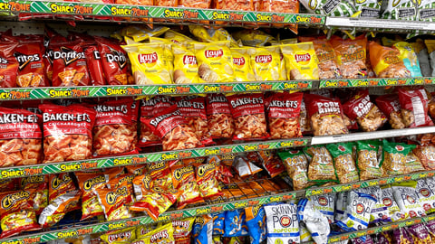 Ros, CA - November 16, 2020: Variety of chips and other dry bag snacks on a shelf inside Dollar Tree store. ￼; Shutterstock ID 1858072885