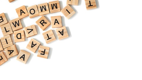 Top view of square wooden tiles with the English alphabet scattered on a white background with space for text. The concept of thinking development, grammar.; Shutterstock ID 1938582667