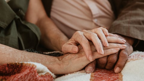 Senior couple holding hands together; Shutterstock ID 1968628894