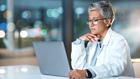 Laptop, doctor and senior woman in hospital working late or overtime on email, telehealth or research. Bokeh, thinking and female medical physician reading healthcare information at night on computer; Shutterstock ID 2256248509