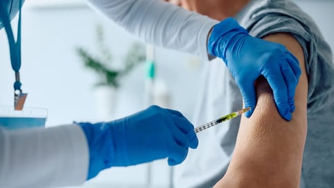 Close up of senior man receiving vaccine while recovering in the hospital.; Shutterstock ID 2314256187