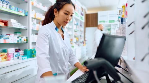 Female Chinese pharmacist using computer while working in a pharmacy. ; Shutterstock ID 2320079431