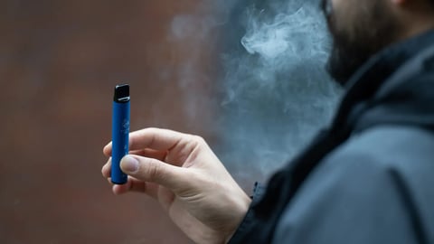 London, UK. 8 August 2023: A man vaping an e-cigarette in London.  Local councils are calling for the Government to ban the sale and manufacture of single-use vapes by 2024. ; Shutterstock ID 2344812279