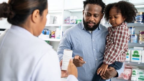 Pharmacist talking with customer at pharmacy counter. She tells customers about drug information at the pharmacy.; Shutterstock ID 2374509269