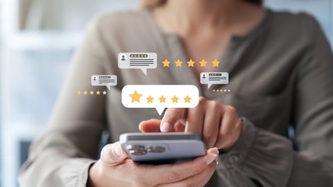 Female customers evaluate the quality of products and services, giving a maximum rating of 5 stars through an online application to gather experience data.; Shutterstock ID 2492412217