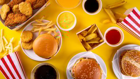 Fast food delivery menu background with various burgers, cheeseburger, nuggets, french fries, fizzy soda drinks. Junk unhealthy fast food, Ultra processed food with low nutrition, high calories value; Shutterstock ID 2505627811