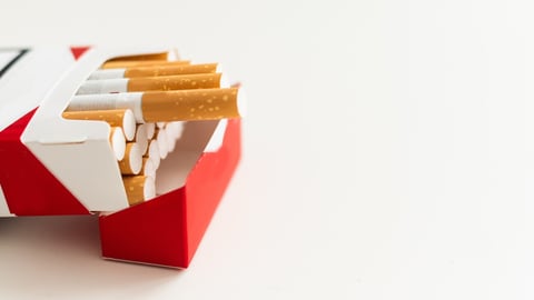 Open pack of cigarettes on a white background; Shutterstock ID 2510814349