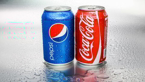 SABAH, MALAYSIA - March 08, 2015: Coca-Cola and Pepsi cans on metal background.