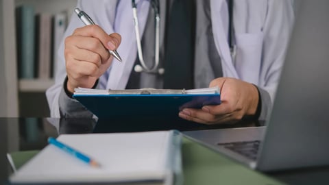 Medical doctor hand hold pen, check patient report on clipboard. Work clinic office desk, laptop. Healthcare concept. Fill prescription form, diagnosis, review insurance, medical record, analysis.; Shutterstock ID 2694908155