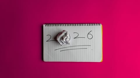 Happy New Year 2026 and a notepad on a colored background. Layout for writing annual business plans, schedules, as well as New Year's resolutions and goals.; Shutterstock ID 2708583667